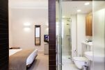 Bedroom and Bathroom, Suffolk Lane Serviced Apartments, London
