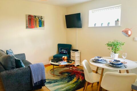 Living Dining area set in modern cosy setting as a home away from home. Sofa bed, coffee table, TV with cable, Free WIFI, books and games also.