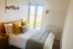 Bedroom with double bed, bedside tables with touch lamps. Double mirrored wardrobes with laundry basket. Juliet balcony letting in plenty of light. 