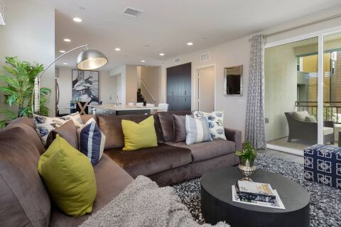 Living area with access to balcony with outdoor seating 