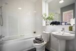 The comfortable and modern bathroom with both shower and bathtub. 