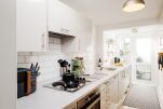 Fully equipped kitchen leading to west facing garden. washer/dryer, dishwasher, microwave, hob oven, 4 slice toaster, kettle, coffee machine. 