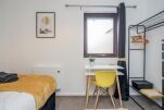 Bedroom 1 with double bed and work desk and chair