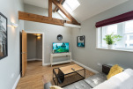 The bright living space of our 1-bedroom penthouse apartment