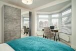 Double bed in apartment 4 with desk